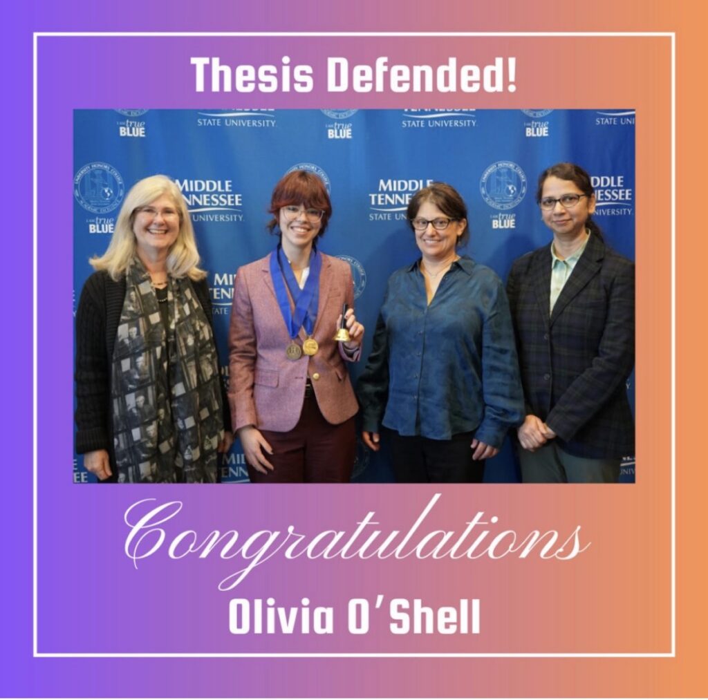 Group photo of Olivia O’Shell with three faculty members at Middle Tennessee State University, celebrating her honors thesis defense; Olivia wears medals and holds a bell in front of an MTSU backdrop.